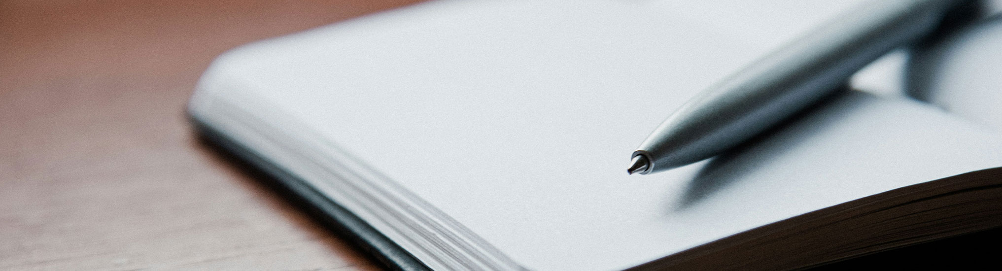 Close up of a ballpoint pen on an open notebook